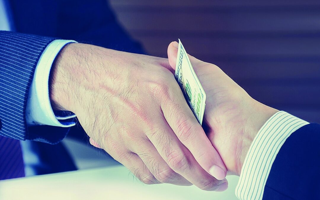 Handshake of businessmen with money, bribery concept – vintage tone