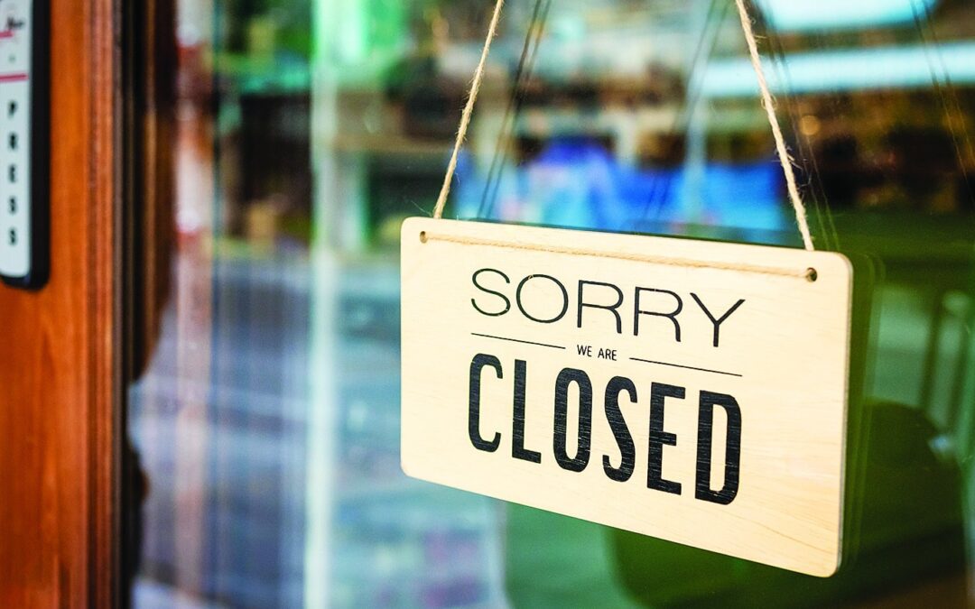 Sorry we are closed sign board hanging on door of cafe